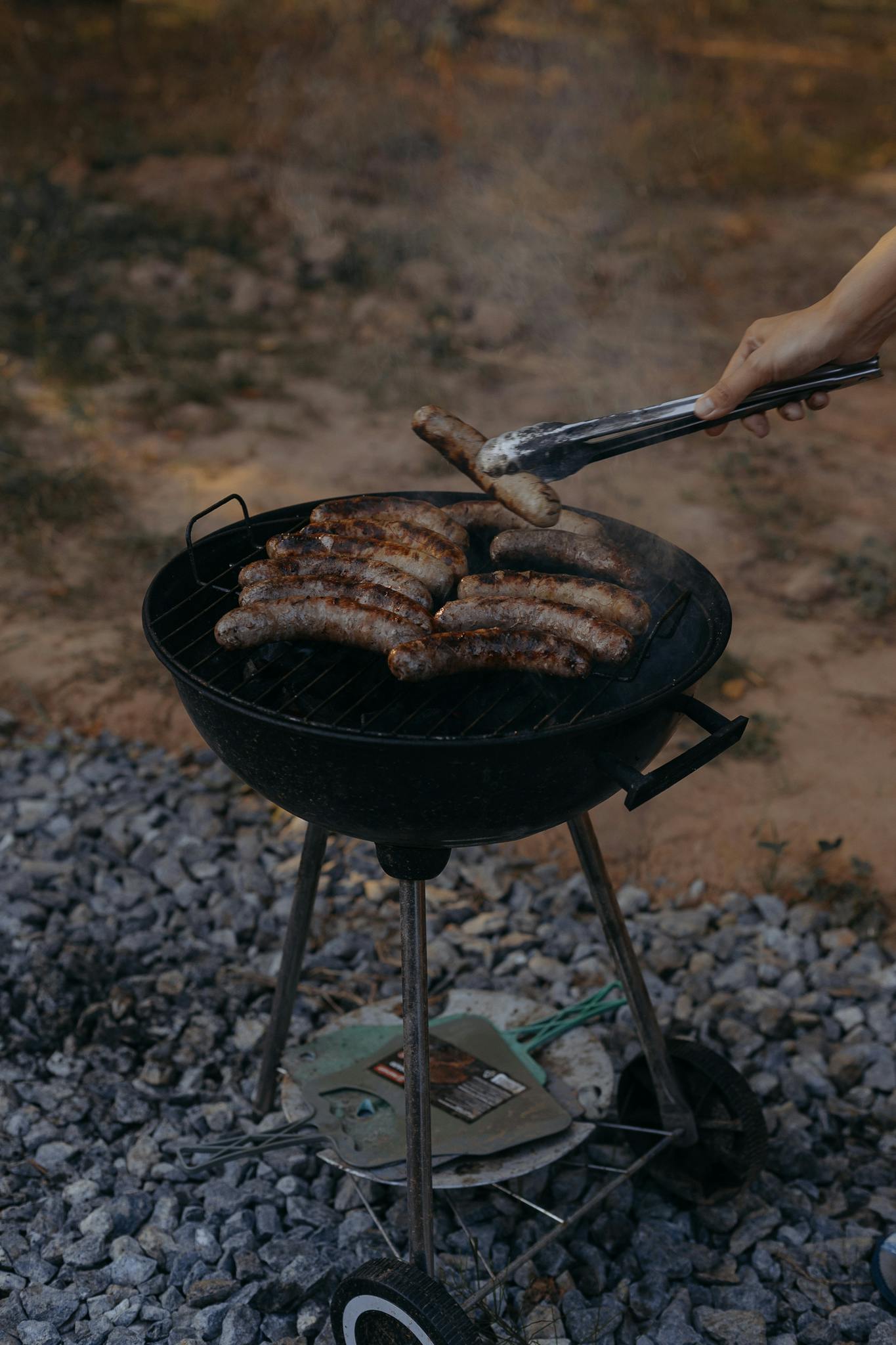 Tasty sausages being grilled on an outdoor barbecue. Perfect for summer gatherings and barbeques.